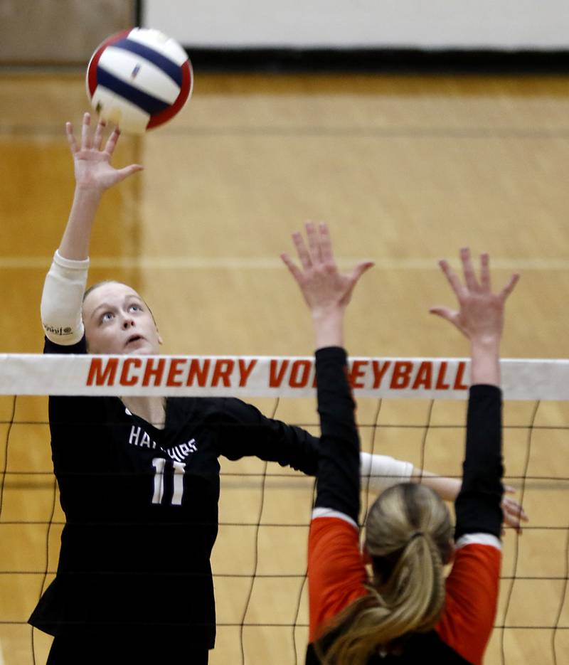 Hampshire's Jorah Rutter hits the ball over Libertyville's Molly Lyon during an IHSA Class 4A McHenry Sectional volleyball match on Tuesday, Nov. 5, 2024, at McHenry High School Freshman Campus.