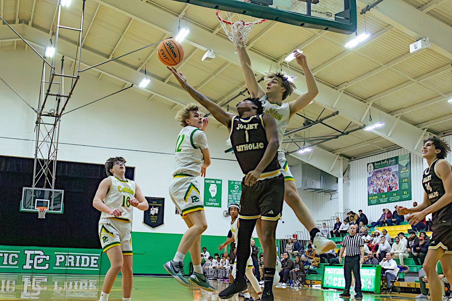 Joliet Catholic's Jayden Armstrong goes up for a reverse layup in Saturday's game against Providence.