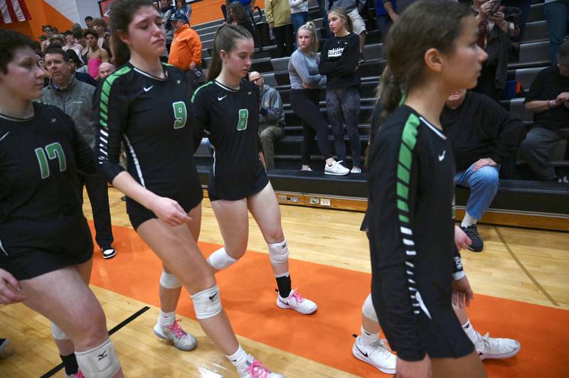 Rock Falls’ Sophie Chavira, Cadence Williamson, and Ryler Johnson walk off the court after falling to Genoa-Kingston in two sets Wednesday, Nov. 2, 2022.