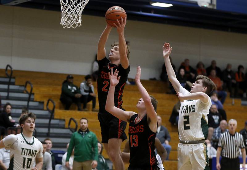 Crystal Lake Central's Jason Penza grabs a rebound in front of his teammate, Jake Terlecki, and Boylan’s Aidan Hocking during a IHSA Class 3A boys basketball regional boys basketball game Thursday, Feb. 23, 2023, at Woodstock High School.