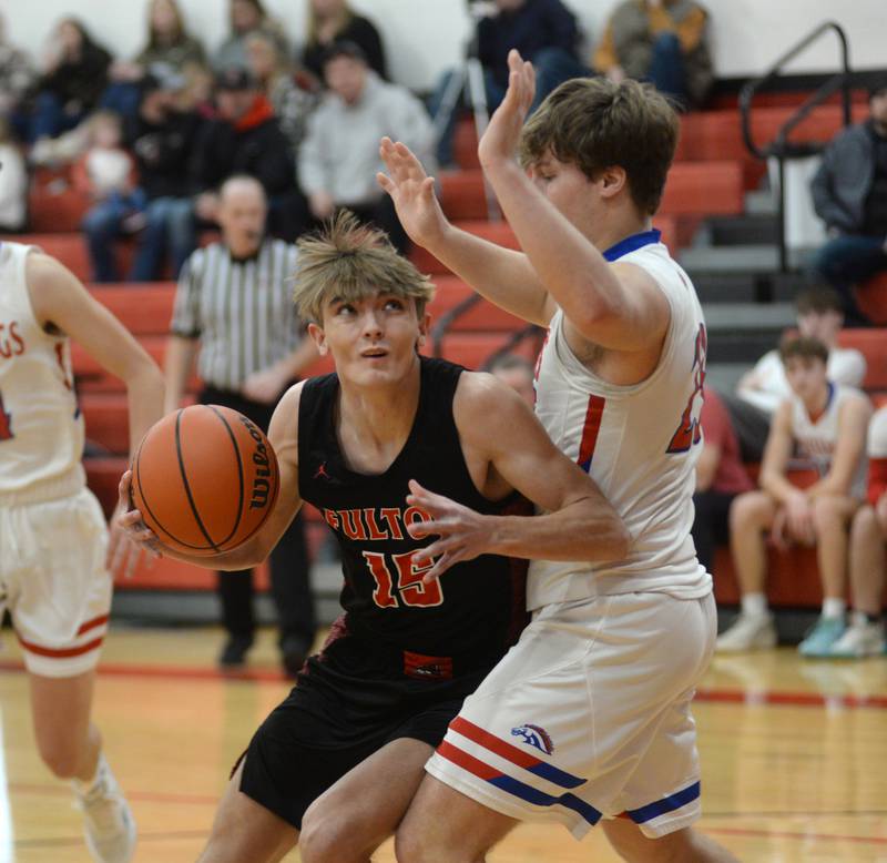 Fulton's Colten Randecker (15) makes a move to the basket as Morrison's Carson Strating (23) defends on Saturday, Dec. 30, 2023 at the Warkins Memorial Tournament at Erie High School.
