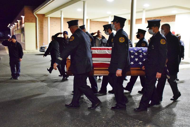Members of the Sterling Fire Department carry the casket containing the body of Lt. Garrett Ramos