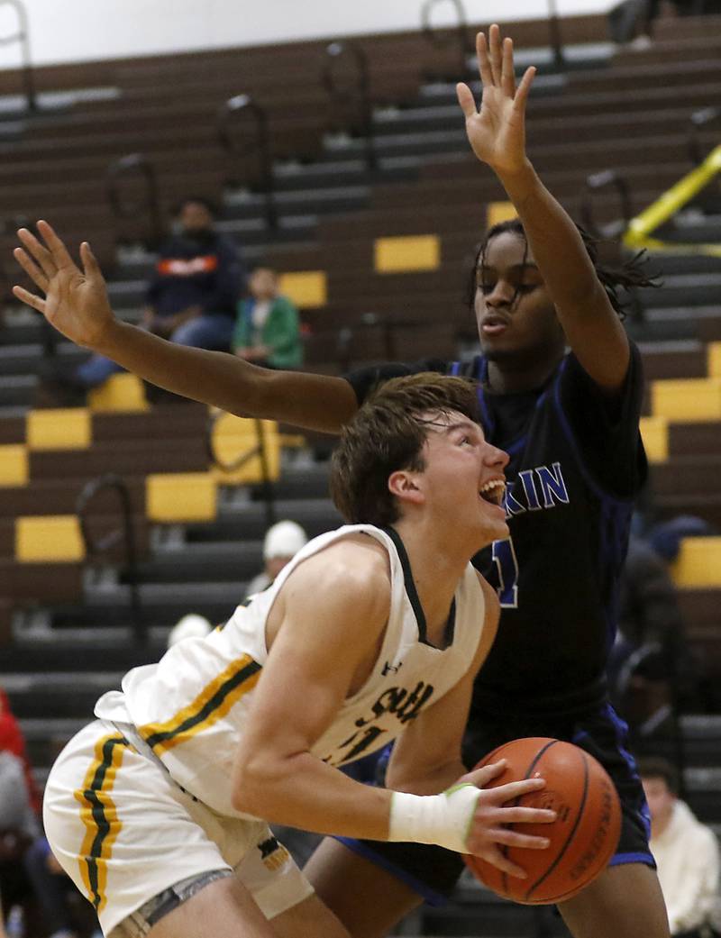 Crystal Lake South's Zachary Peltz tries to fake out \LArkin’s Joshua Hibbett during a Hinkle Holiday Classic basketball game Wednesday, Dec. 28, 2022, at Jacobs High School in Algonquin.