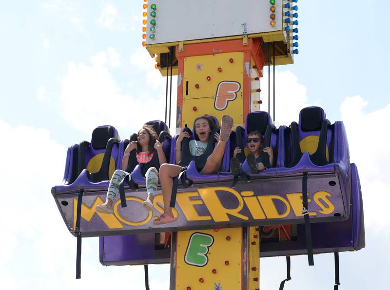 Children including (left-right) Alice Behary of Brookfield, Magdalena of Brookfield and Alex Dovantzis of Chicago react to riding the free fall at the La Grange Summerfest Saturday Aug 6, 2022.