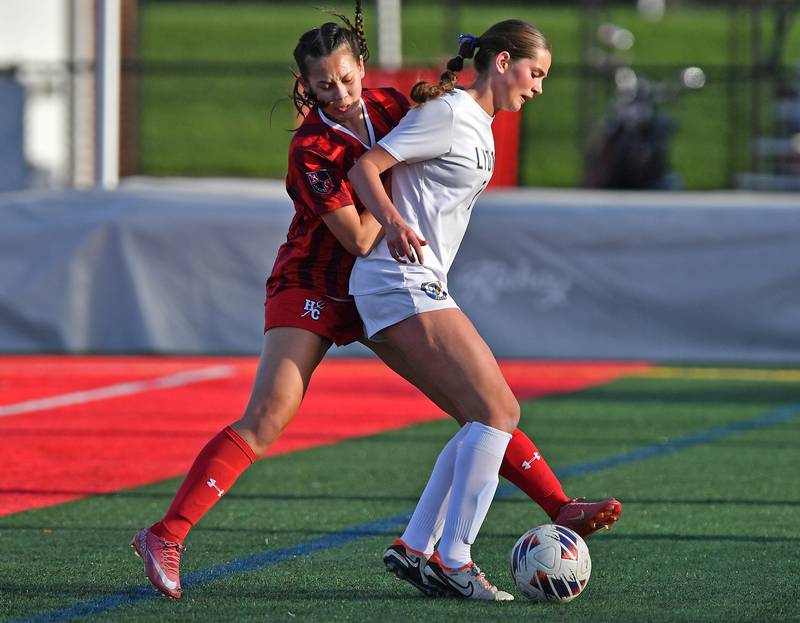 Lyons Township’s Caroline Mortonson tries to control the ball while Hinsdale Central’s Cara Groom defends during a game on April 29, 2025 at Hinsdale Central High School in Hinsdale.