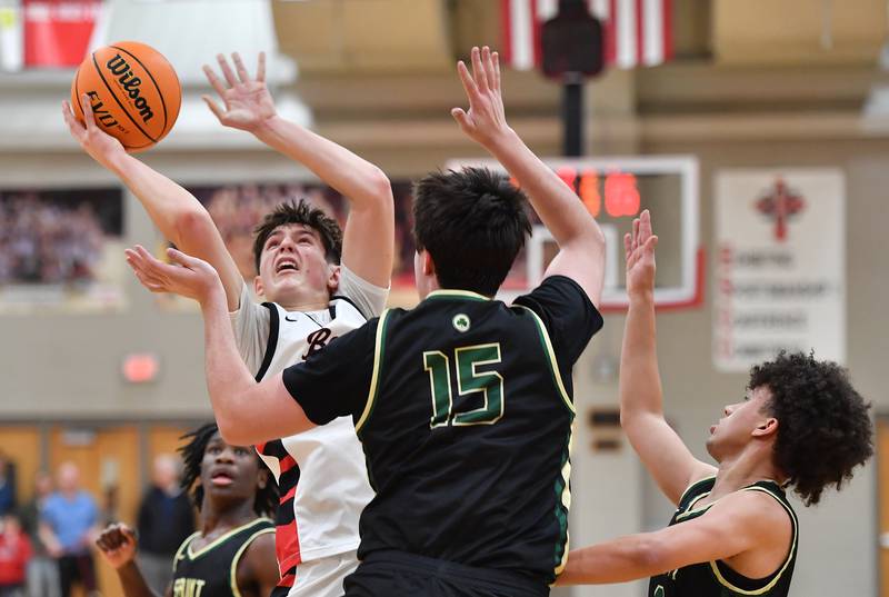 Benet’s Edvardas Stasys puts up a shot while surrounded by St. Patrick defenders during a game on January 17, 2025 at Benet Academy in Lisle.