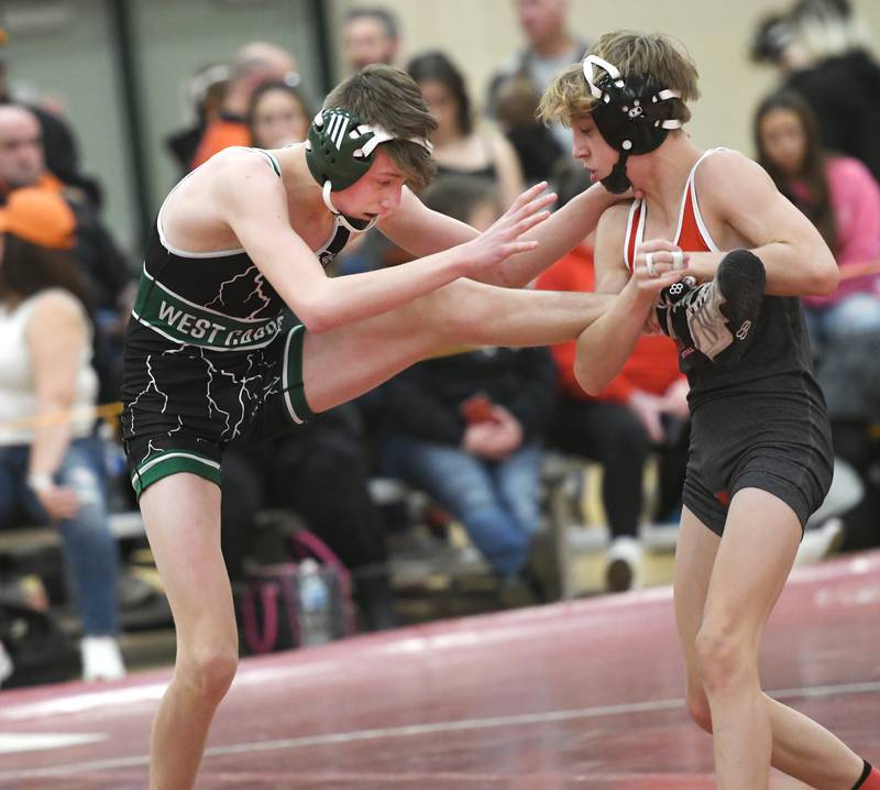 West Carroll's Connor Knop (left) tries to escape a hold by Woodstock Marian's Austin Hagevold during their 106-pound match at the 1A Oregon Wrestling Sectional on Friday night.