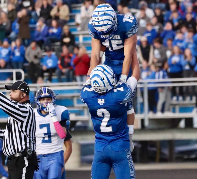 Teegan Davis lifts Princeton's Augie Christiansen after a Tiger touchdown during Friday's 3A Playoff opener against Peotone at Bryant Field. The Tigers won 56-28.