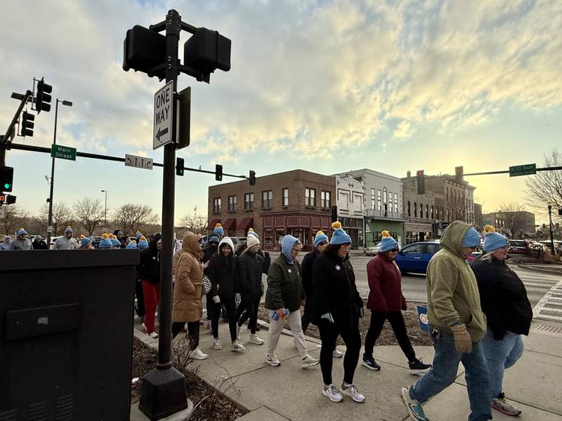 A group of walkers moves along the route during the "Coldest Night of the Year" mile-long walk Saturday night at Jordan Block Park in downtown Ottawa. The event featured more than 110 walkers representing 18 teams.