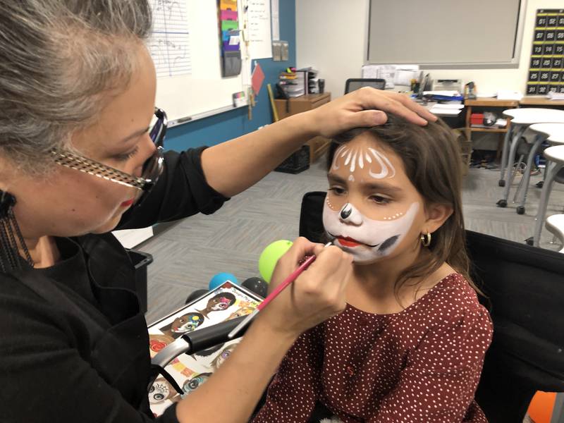 Charity Semeraro painted Joscelyn Garcia's face on Saturday, Nov. 4, as part of the Latin American Student Organization's Día de Los Muertos celebration at McHenry High School.