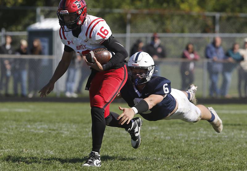 Cary-Grove's Jeremiah Benford tries to tackle Huntley's Braylon Bower from behind during a Fox Valley Conference football game on Saturday, Oct. 7, 2023, at Cary-Grove High School.