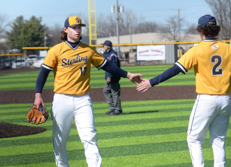 Sterling's Eli Penne (17) slaps hands with  Adrian Monarrez (2) after pitching a complete game for a 2-0 win over Erie-Prophetstown on Saturday, March 22, 2025 in Sterling.