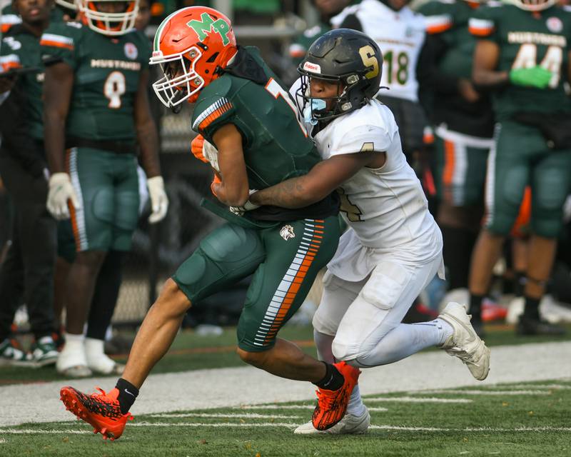 Sycamore’s Tyler Curtis (4) takes down Morgan Park’s ball carrier Johnovan Wysinger (7) during the second quarter of the game on Saturday Nov. 4, 2023, held at Gately Stadium in Chicago.