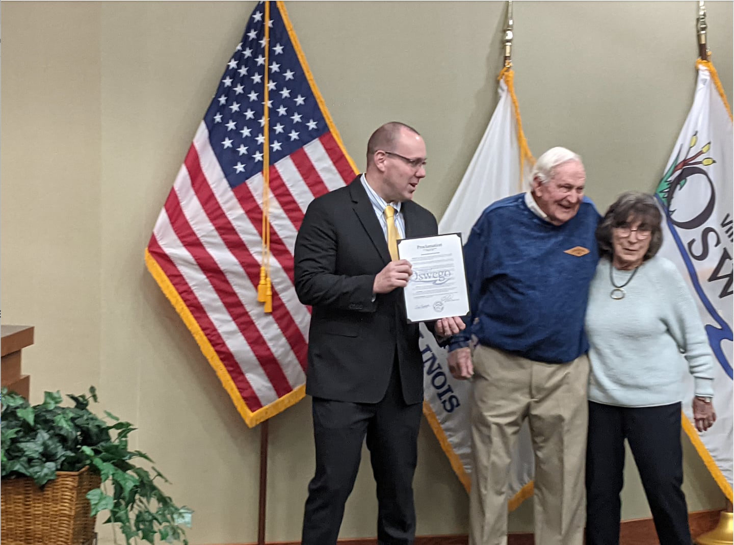 At the Nov. 18 Oswego Village Board, meeting, Oswego Village President Ryan Kauffman, far left, read a proclamation honoring Brad Smith and his wife, Judy. The couple has lived in Oswego since 1951.