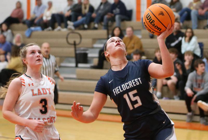 Fieldcrest's TeriLynn Timmerman runs past Flanagan-Cornell/Woodland's Emma Palaschak to score on a layup during the Falcon-Irish Thanksgiving Tournament on Monday, Nov. 18, 2024 at Flanagan High School.