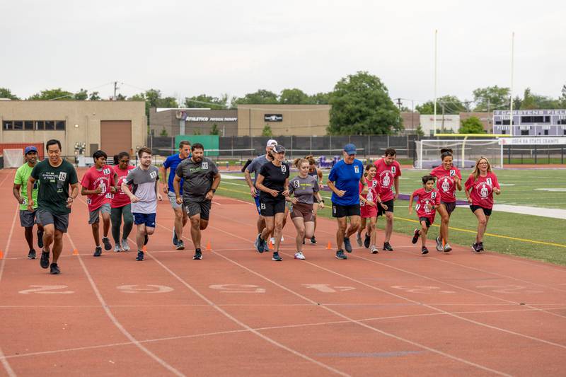 A group of runners begin their first lap at Ben’s Memorial Mile, a community festival held every summer to raise money and awareness for mental health and suicide prevention in honor of Ben Silver, on Saturday, July 22, 2023.