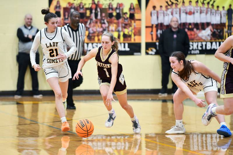 Watseka's Kami Muehling evades Reed-Custer's Leah Grace, right, and Alyssa Wollenzien during the Warriors' 50-24 victory over Reed-Custer in the IHSA Class 2A Herscher sectional semifinal on Tuesday, Feb. 25.