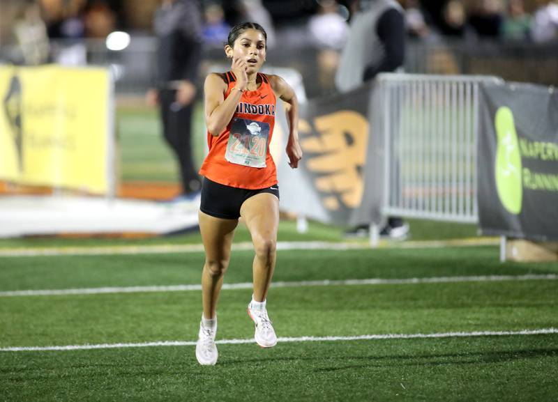 Minooka’s Maya Ledesma comes in second in the varsity girls race during the Naperville North Twilight Cross Country Invitational on Wednesday, Oct. 9, 2024 in Naperville.