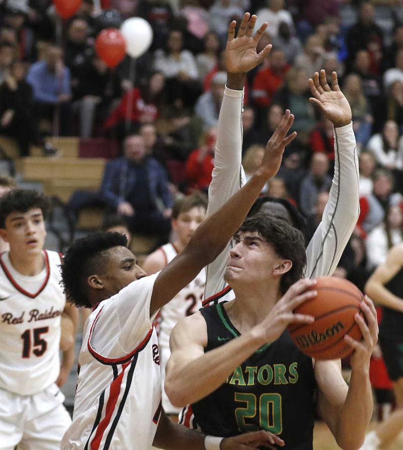 Crystal Lake South's Christopher Regillio drives to the basket against Huntley's Bryce Walker during a Fox Valley Conference boys basketball game Tuesday, Feb.6, 2024, at Huntley High School.