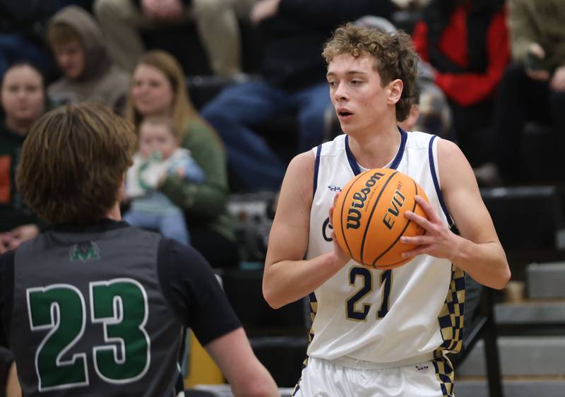 Marquette's Lucas Craig looks to pass the ball around Midland's Dominic Rosa during the Tri-County Conference Tournament on Monday, Jan. 26, 2026 at Putnam County High School