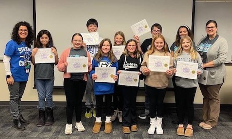 Heartland Elementary School Principal Kimberly Hornberg, (left) stands with Student Council members who received the Viking Leaders Award Jan. 22, 2024 for participating in Adopt-A-Highway: Alina Zadro, Maggie Helland, Sophia Behrens, Charlotte Mulcahy, Ginny Brylka, JJ Rooney; back row Eliseo Sida, Kendall Harbach, Nate Apgar and teachers who sponsor the Student Council Christine Jennings and Jessica Yonkman. (Not pictured but also receiving the award were Emma Ciemny Adele Crosetti.)