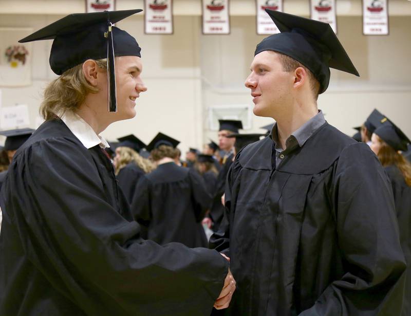 Nick Allen and Samuel Arand congratulate each other before the Kaneland High School Class of 2023 Graduation Ceremony on Sunday, May 21, 2023 in DeKalb.