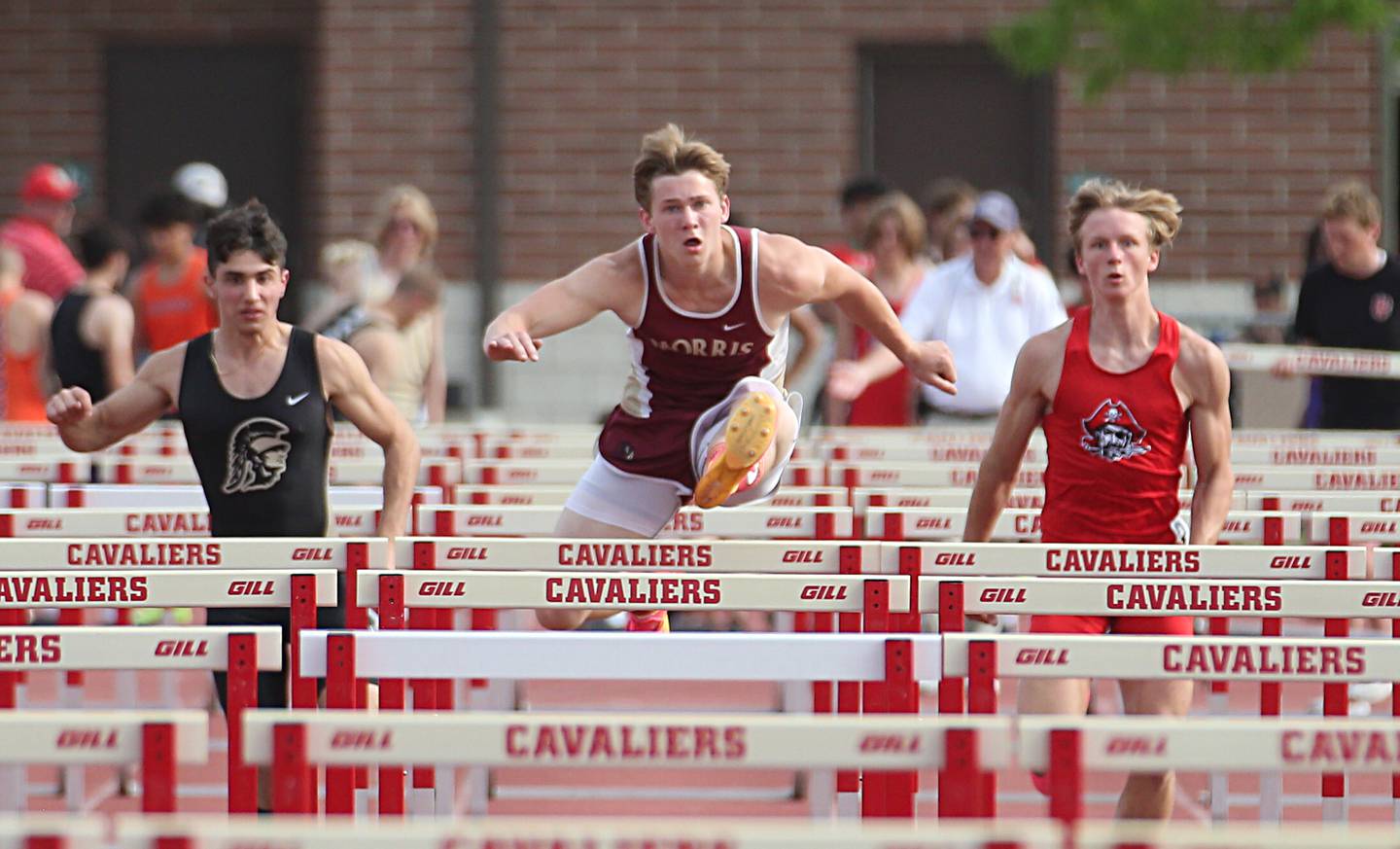 Sycamore's Vincent Brito, Morris's Noah Smith and Ottawa's Weston Averkamp run the 110 meter hurdles during the I-8 Boys Conference Championship track meet on Thursday, May 11, 2023 at the L-P Athletic Complex in La Salle.
