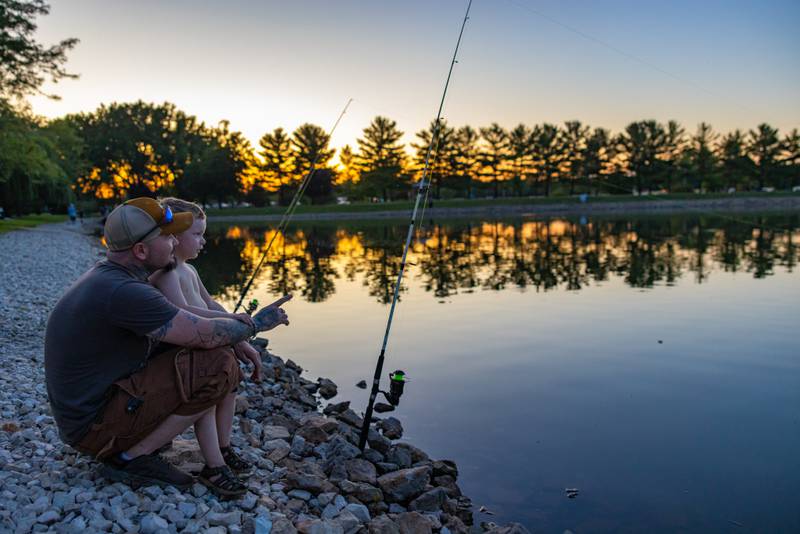 Cameron Ogle teaches his son Tommy how to fish prior to the start of the fireworks on June 28, 2025 at Lake Mendota.