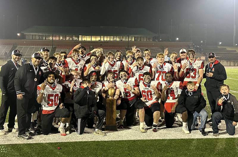 Members of the Amboy/LaMoille/Ohio football team pose with the 8-man I8FA championship trophy on Friday, Nov. 21, 2025 at April Zorn Memorial Stadium in Monmouth.