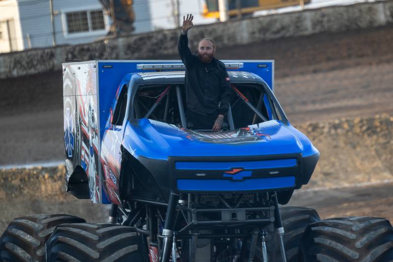 Josh Holman waves to crowd from windshield of the Monster Truck 'Rescue Racer' at the Monster Truck Bash on Saturday, Sept. 13, 2025 at the La Salle Speedway in La Salle.