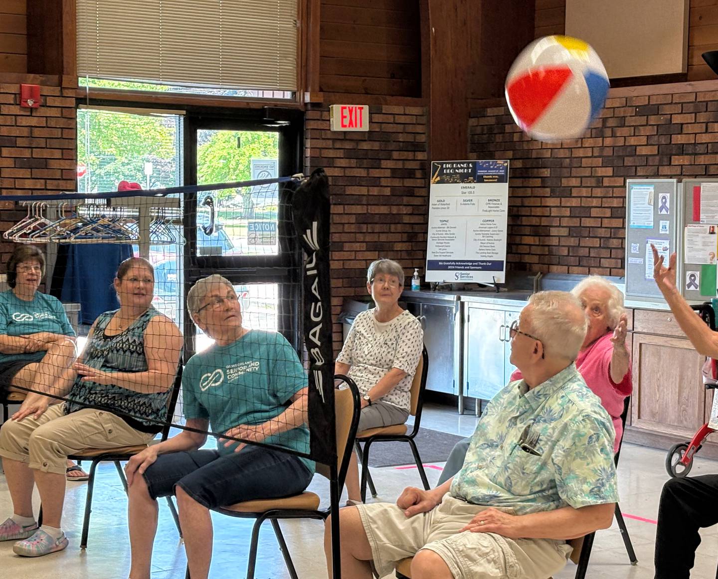Chair volleyball is played six players a side with unlimited hits to return the inflatable beach ball. Pictured, seniors return a volley at the Beecher Center in Yorkville.
