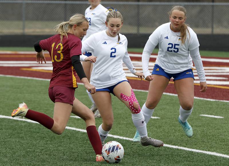 Richmond-Burton's Sydney Frericks tries to take a shot at the goal as she is defended by Johnsburg's Devynn Michel and Jacquelyn Douglas during a Kishwaukee River Conference soccer game on Tuesday, April 1, 2025, at Richmond-Burton High School.