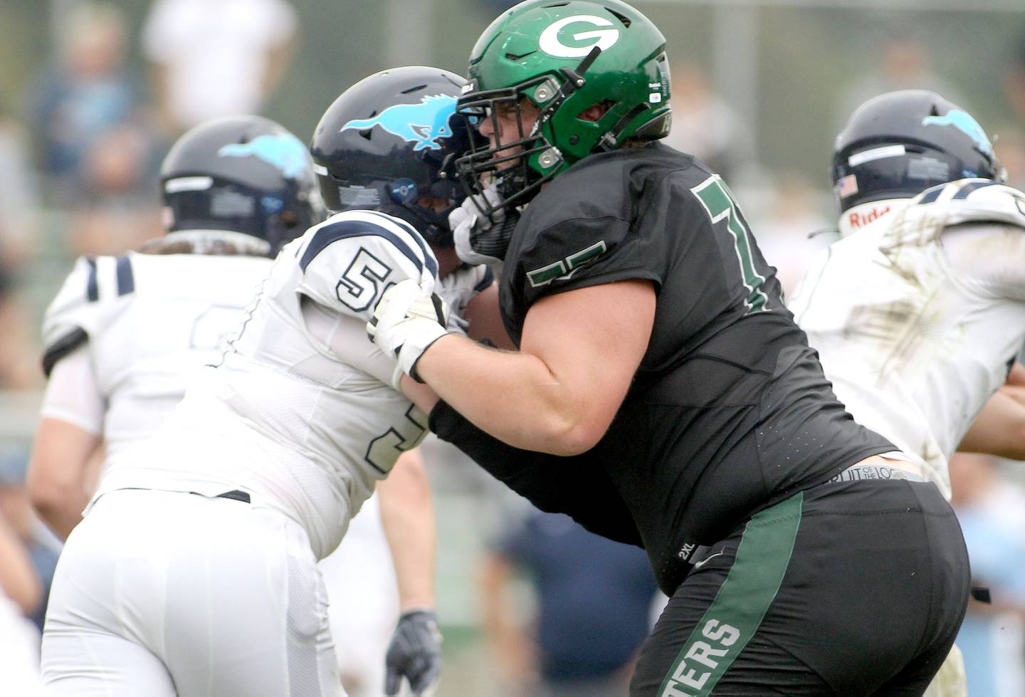 Glenbard West defender Chris Terek (77) goes up against Downers Grove South's Tyler Williams (5) during a game in Glen Ellyn on Saturday, Sep. 4, 2021.