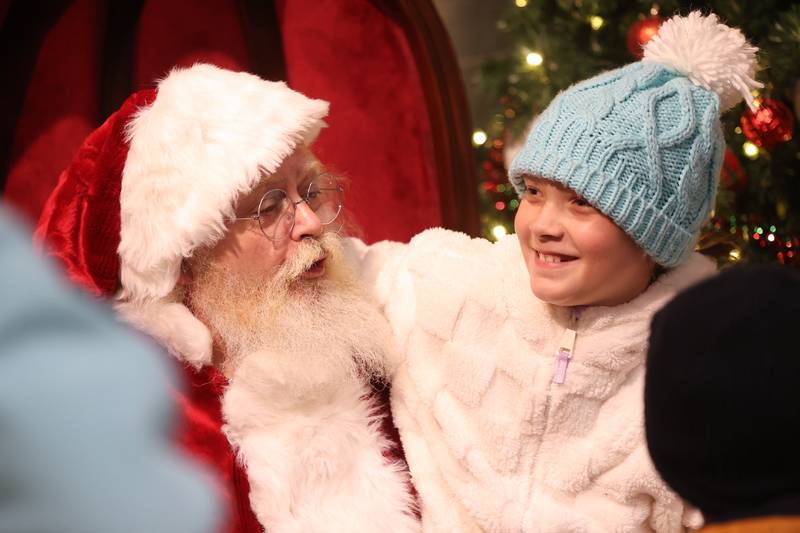 Allie Olszta talks with Santa at the GLOW Holiday Festival at Slammers Stadium on Wednesday, Nov. 27, 2024 in Joliet.