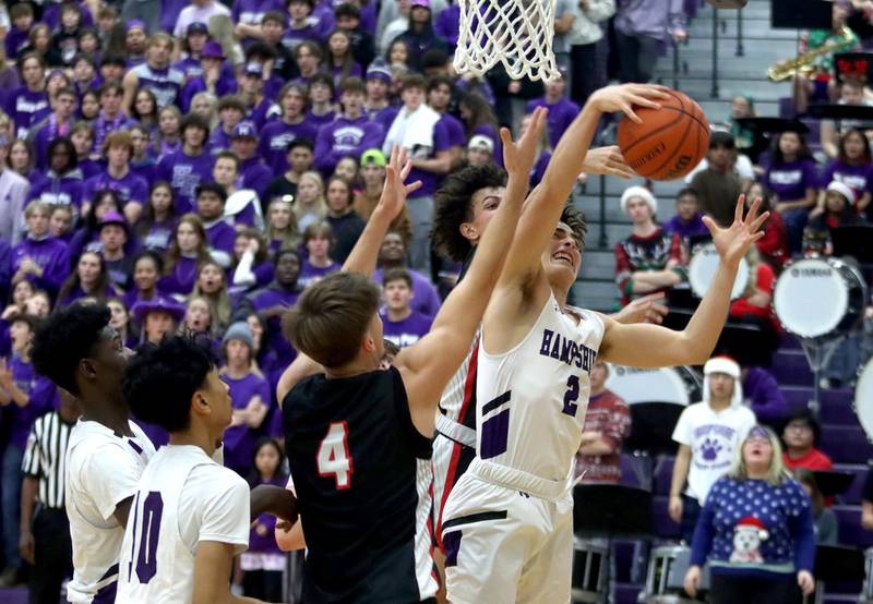 Hampshire’s Joseph Costabile gathers a rebound against Huntley in boys basketball at Hampshire on Friday.