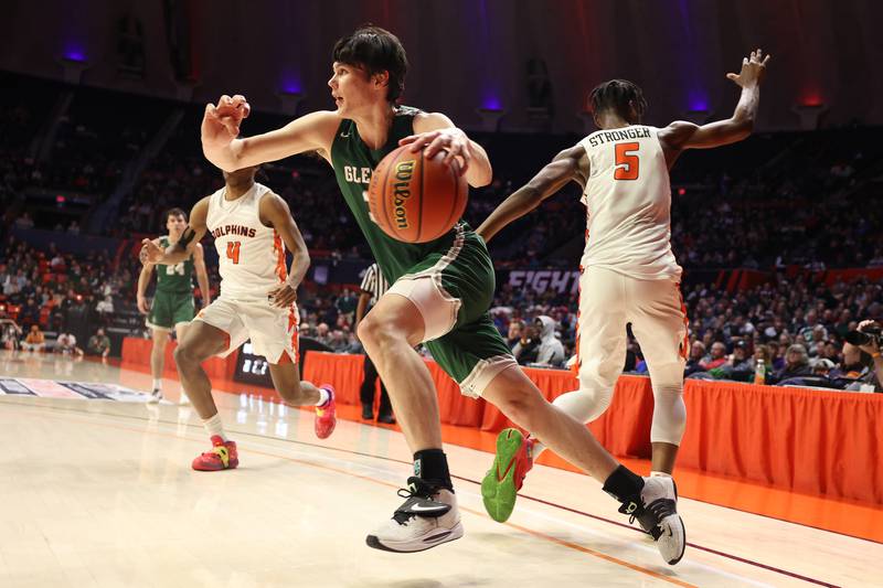 Glenbard West’s Bobby Durkin drives around a Whitney Young defender in the Class 4A championship game at State Farm Center in Champaign. Saturday, Mar. 12, 2022, in Champaign.