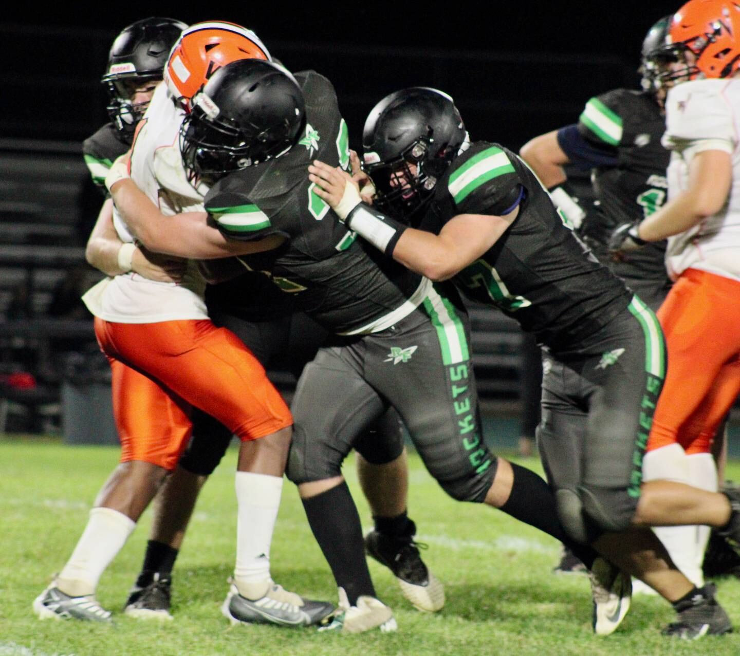 Rock Falls' Ethan Hiland (32) leads the tackle on the Winnebago ball carrier on Friday in Rock Falls.