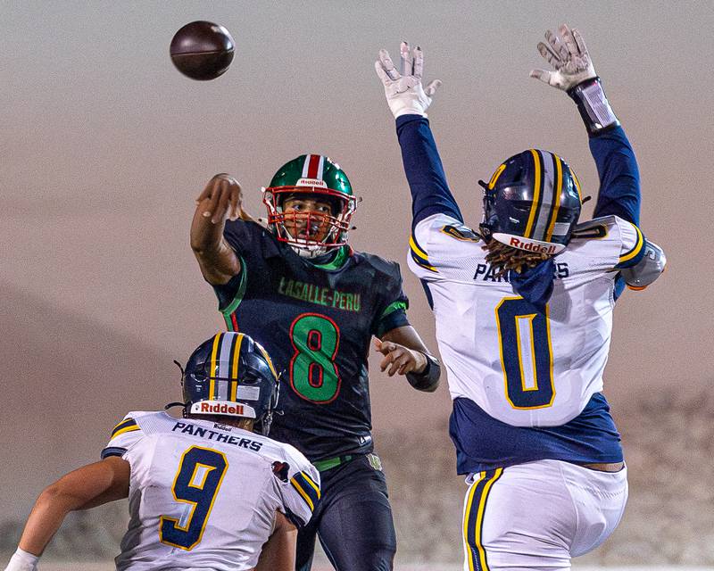 Marion Persich (8) of L-P throws ball to receiver as Kendrick Douglas Jr. (0) of O' Fallon attempts to block on Friday, October 24, 2025 at Howard Fellows Stadium in LaSalle.