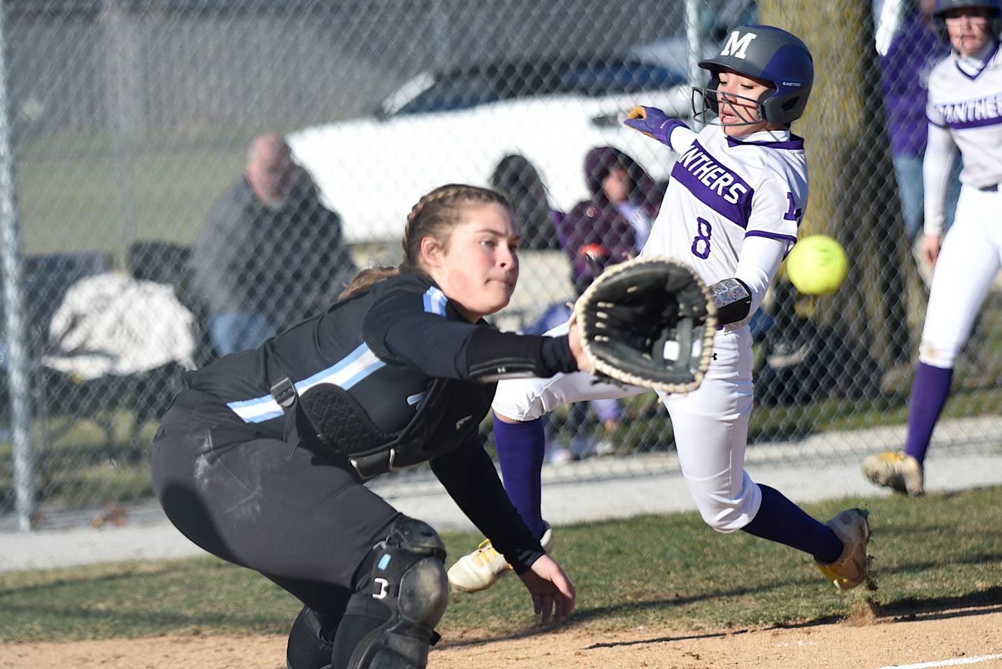 Manteno's Jaz Manau, right, slides into home plate as Kankakee's Kylee Cunningham fields a late throw during a game in Manteno Tuesday, March 25, 2025.