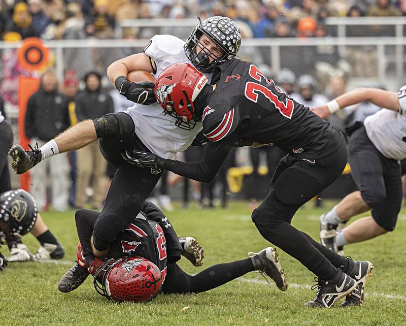 Le/Win’s Gunar Lobdell is stopped by Conner Sheridan and Baylen Damhoff (right) Saturday, Nov. 12, 2022 in a quarterfinal game.