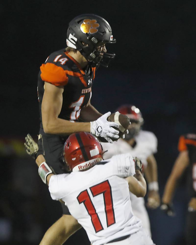 Crystal Lake Central's George Dimopoulos catches the ball as Huntley's Jacob Zastrow tries to tackle him during a Fox Valley Conference football game Friday, Aug. 26, 2022, between Crystal Lake Central and Huntley at Crystal Lake Central High School.