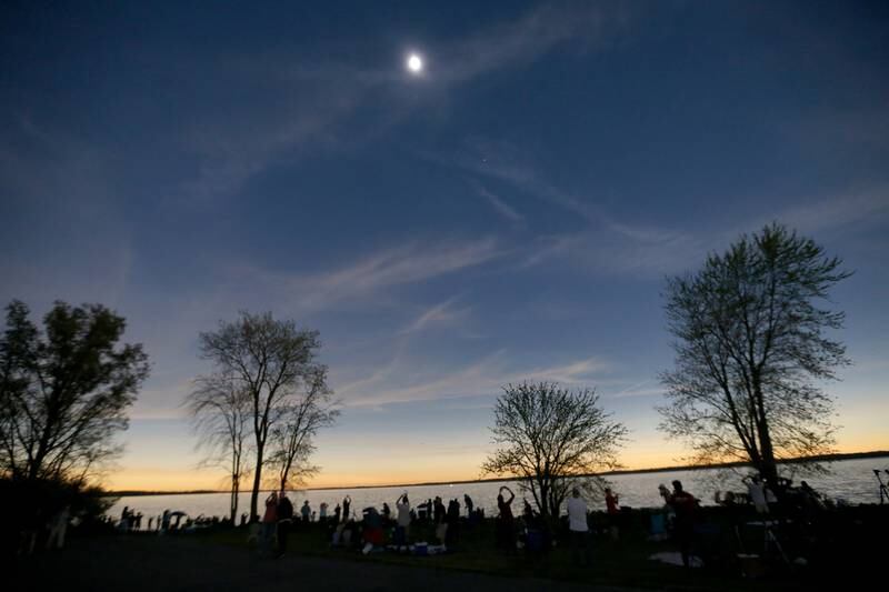 Hundreds of people view the total solar eclipse from Rend Lake near Whittington on Monday, April 8, 2024.