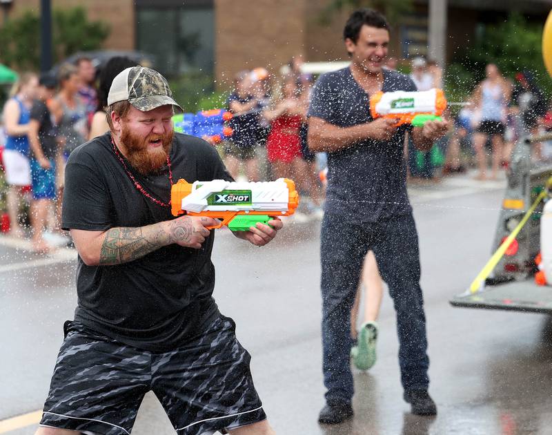 A water fight breaks out in the parade as it heads down Main Street Friday, July 4, 2025, during the Fourth of July parade in downtown Kirkland.