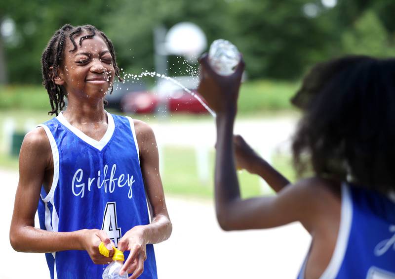 Jonathan Griffey, 12, from DeKalb, gets splashed by his brother Jaice during the Juneteenth Community Celebration Saturday, June 15, 2024, at Hopkins Park in DeKalb.