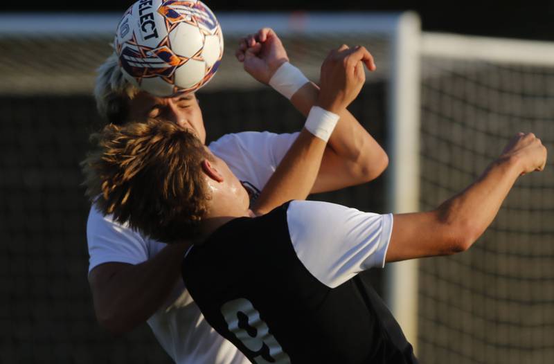 Crystal Lake Central's Alvaro Manzano heads the ball away from Prairie Ridge's Henry Knoll during a Fox Valley Conference soccer match on Thursday, Oct. 10, 2024, at Prairie Ridge High School.