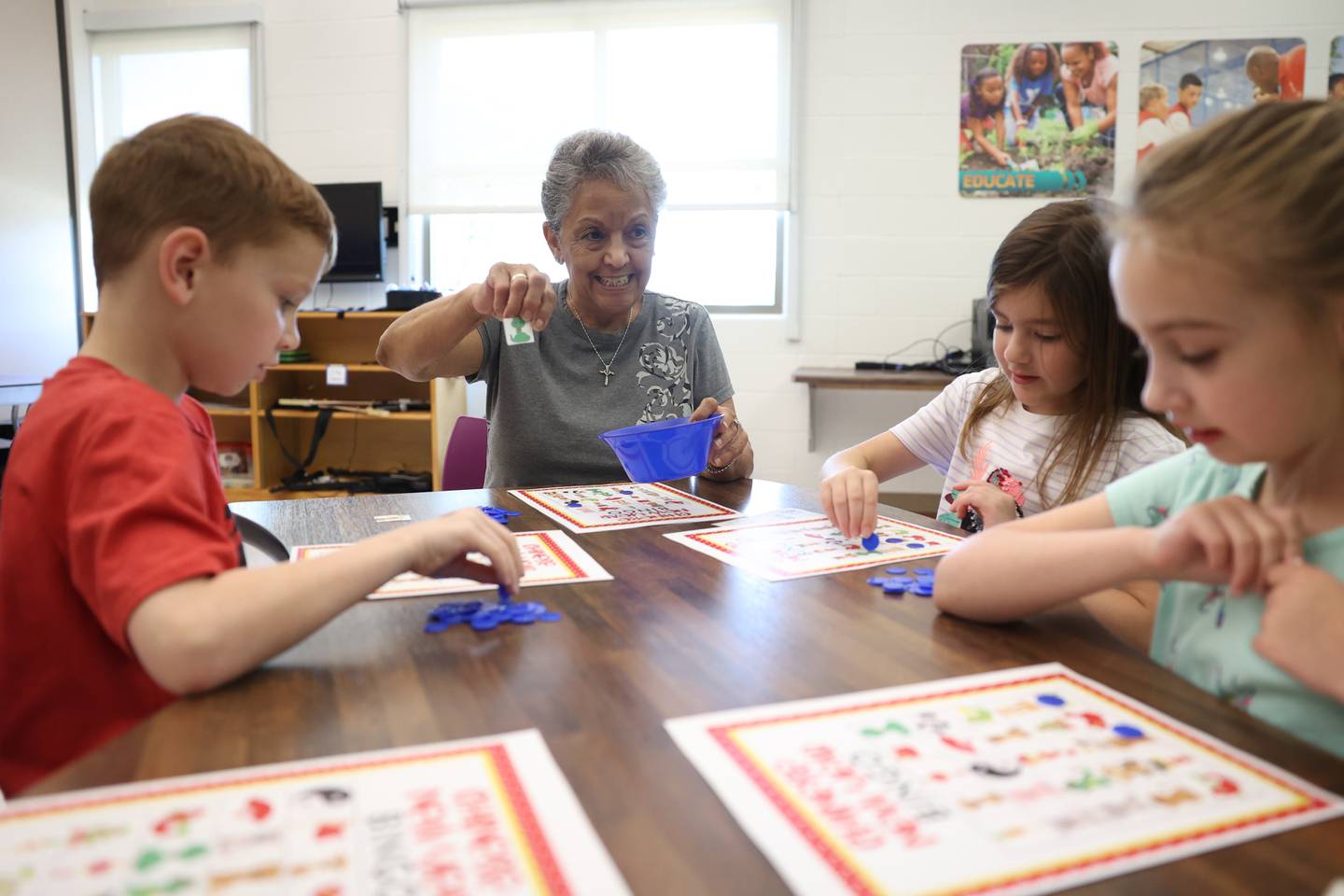 Volunteer Carmen Janega plays BINGO with the children at the C.W. Avery YMCA summer camp in Plainfield. Wednesday, July 20, 2022 in Plainfield.
