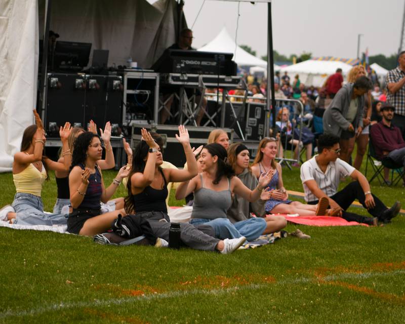 Community members clap along to the music of Marlon and the Shakes during PrairieFest on Thursday June 12, 2025, held at PrairieFest Park in Oswego.