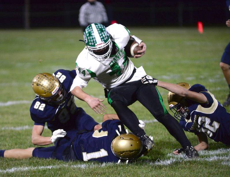 Polo defenders Mercer Mumford (1), Kailin Gulbranson (82), and Billy Lowry (12) tackle Alden-Hebron's Wyatt Armbrust (44) during 8-man playoff action against on Friday, Nov. 1, 2024 in Polo.