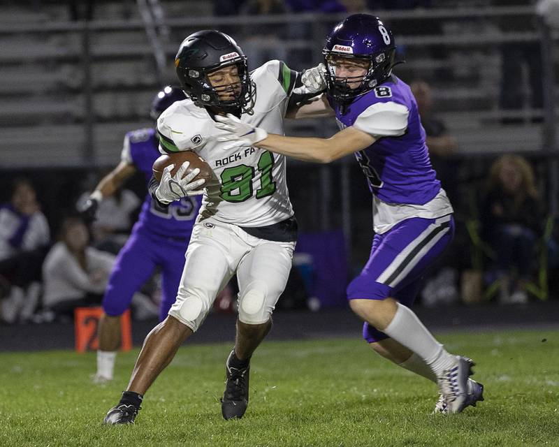 Rock Falls’ Diego Hernandez fight off a tackle from Dixon’s Cort Jacobson Friday, Oct. 21, 2022.