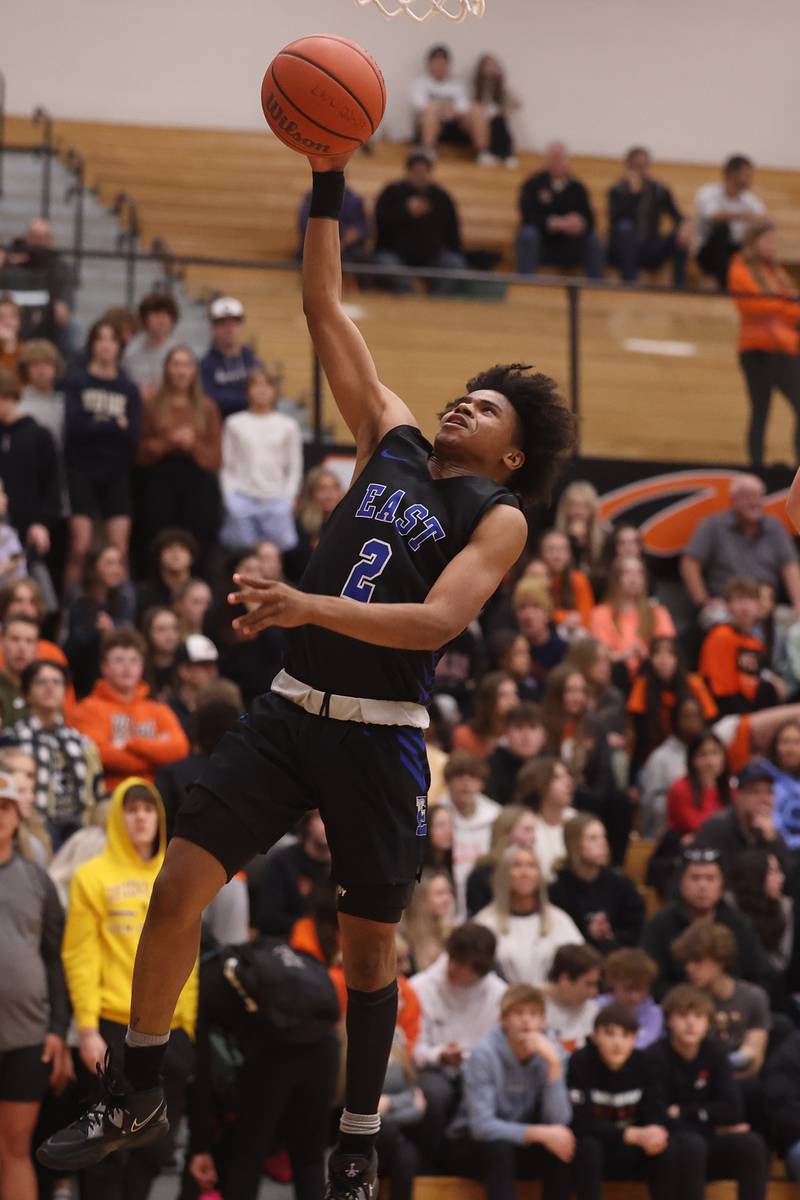 Lincoln-Way East’s Kaiden Ross lays in a shot against Lincoln-Way West.